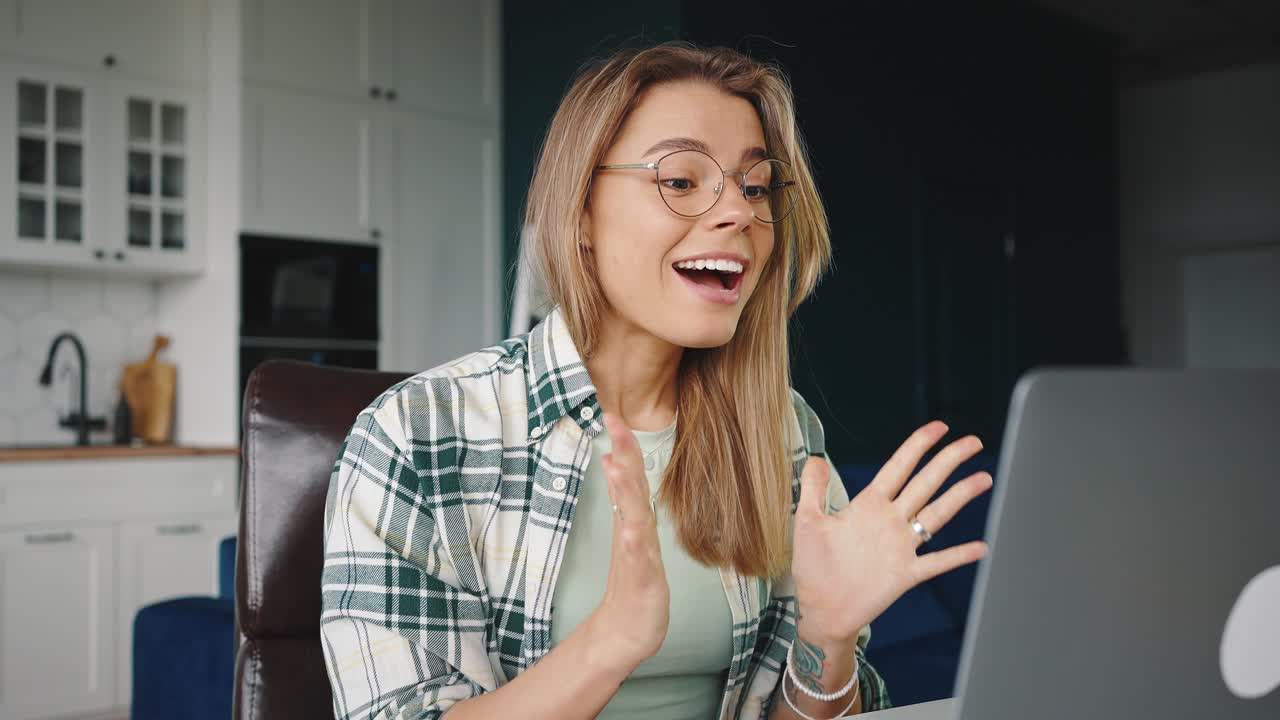 Young woman working on laptop online, getting email with winning information, feeling excited and happy