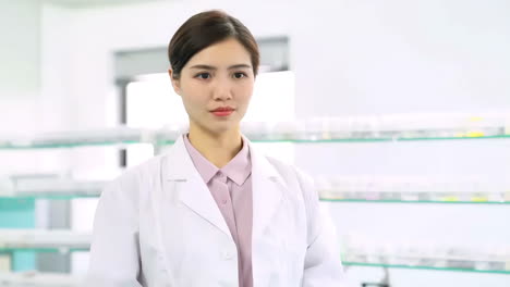 female pharmacist presenting medicine bottle