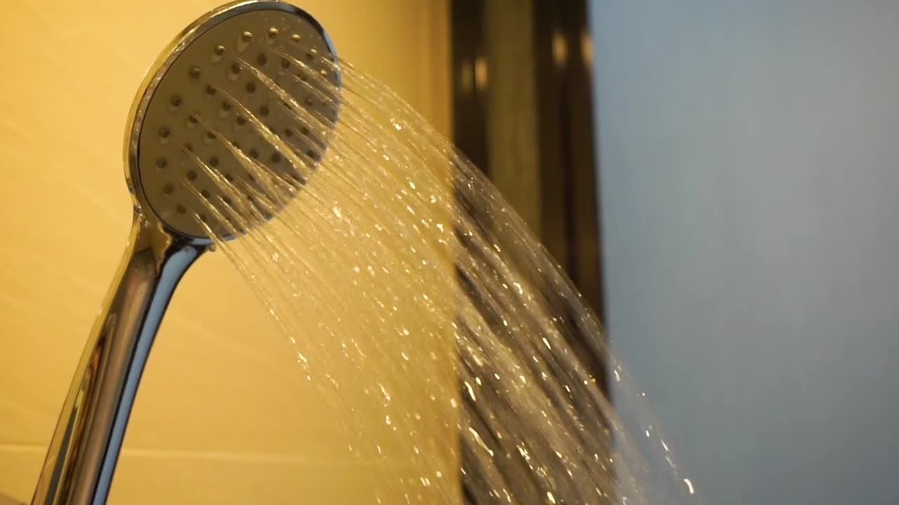 Water is dripping from the shower head