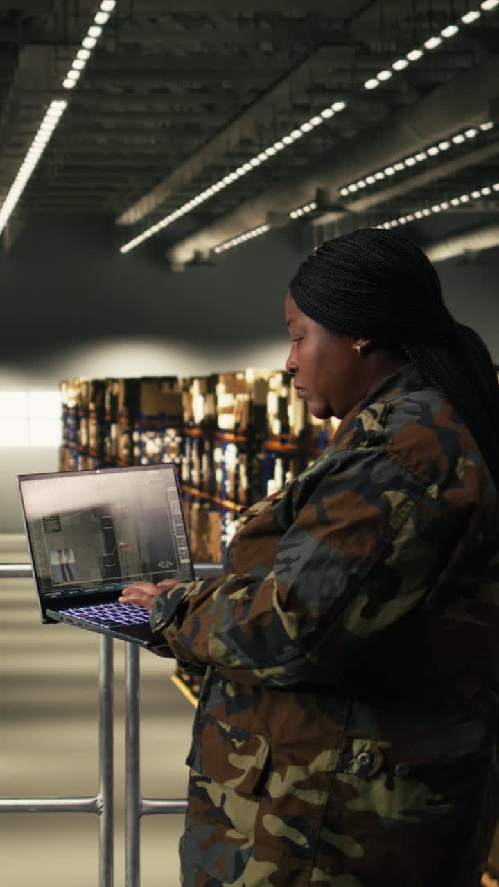 Vertical Video Female soldier operating digital command dashboard for aerial surveillance
