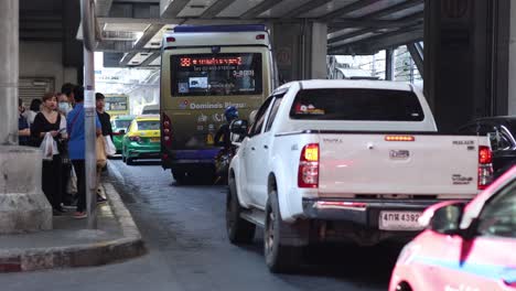 passengers boarding taxis at a bustling station