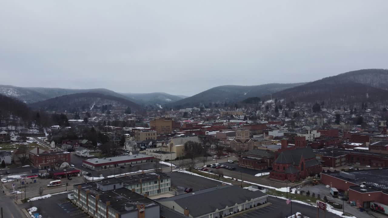 A beautiful aerial panning view of Bradford, Pennsylvania on a dreary winter day