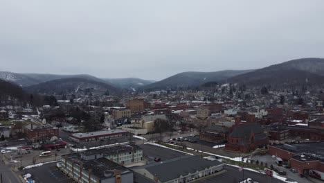 a beautiful aerial panning view of bradford, pennsylvania on a dreary winter day