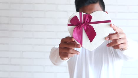 man holding heart shaped gift box