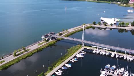 beautiful walkway and docked yachts in gizycko marina, aerial orbit view