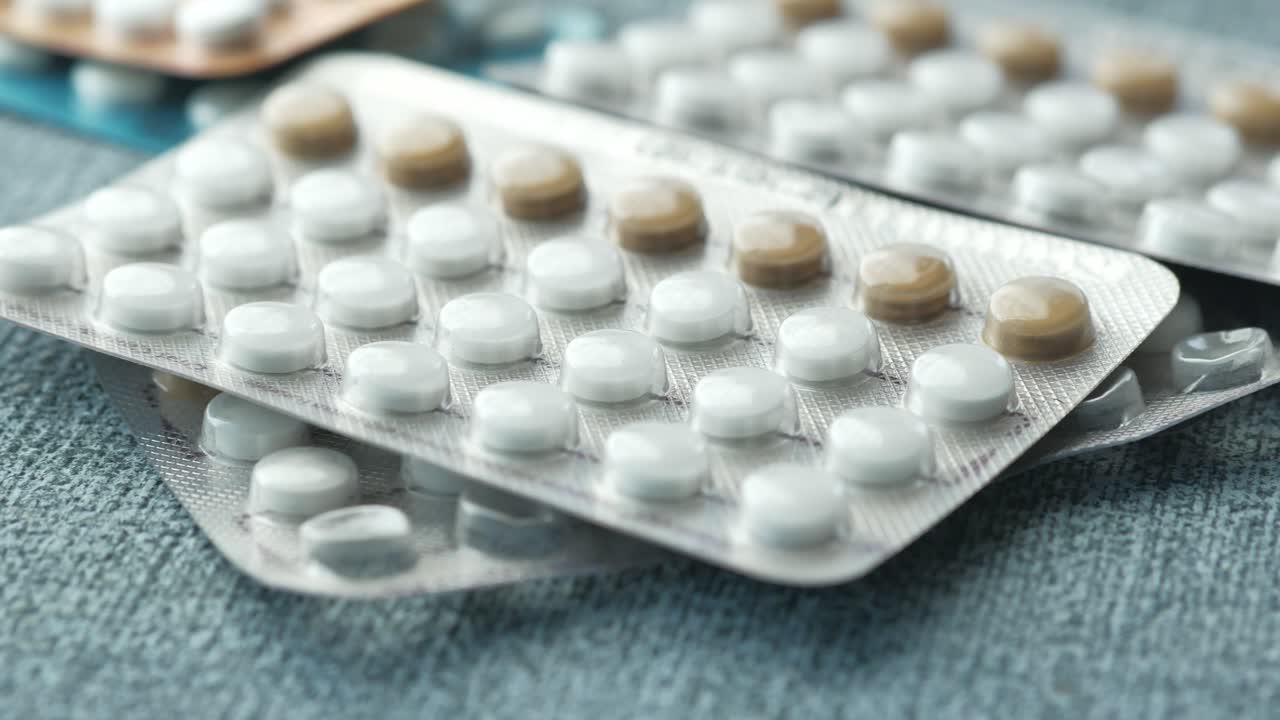 Dropping birth control pills on on table ,