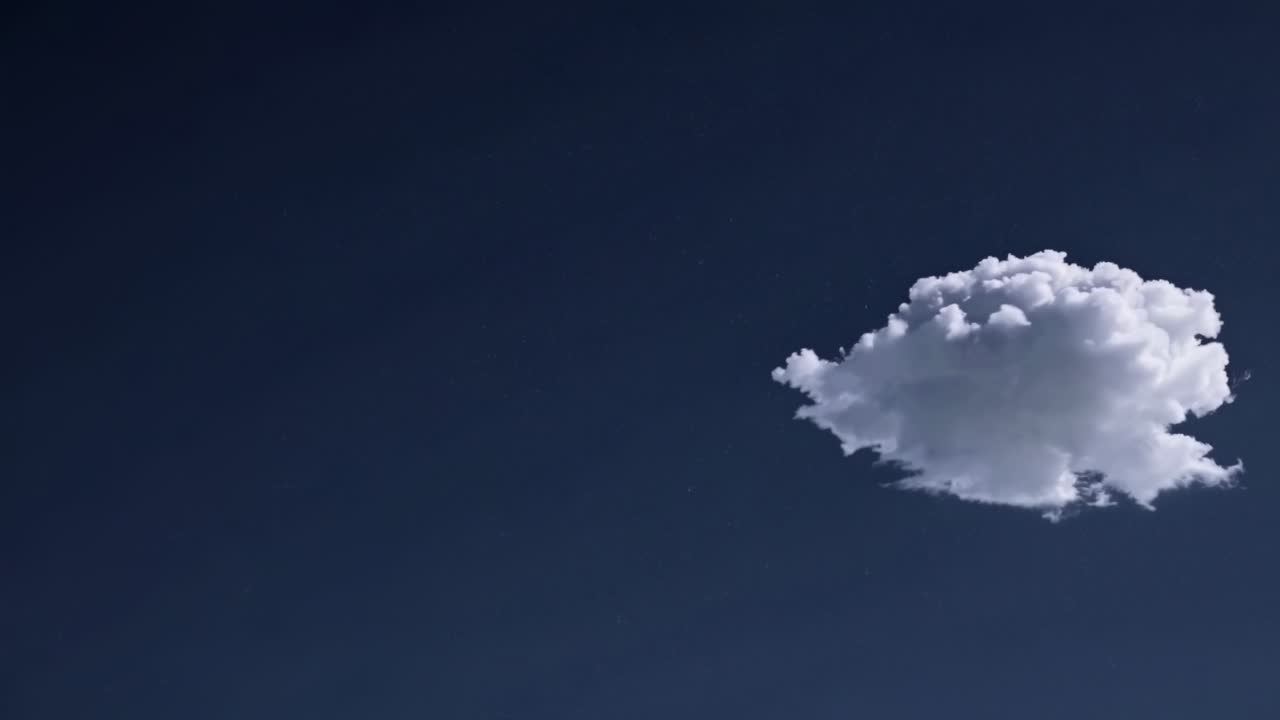 Una singola nuvola soffice fluttua contro un cielo blu intenso, ripresa da una prospettiva dal basso.