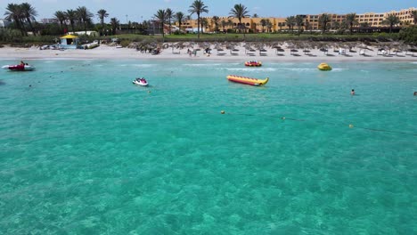 tropical beach resort with clear turquoise waters and water sports