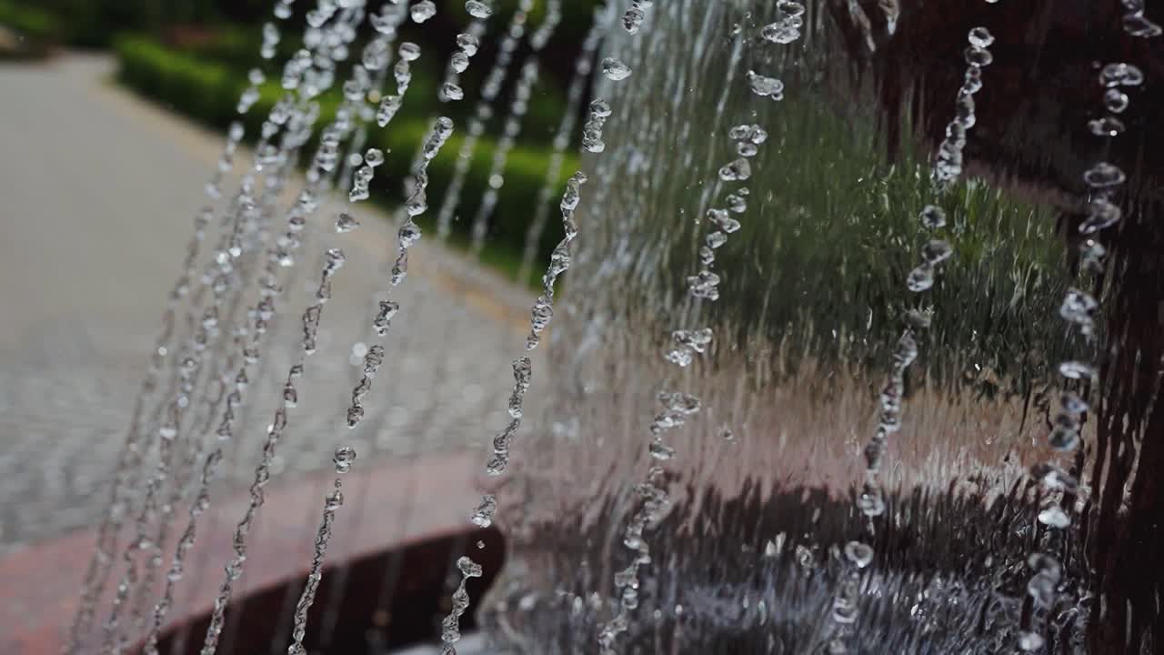 Water of fountain in park. Water streams flowing out of fountain