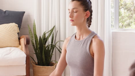 practicing mindfulness breathing exercises, woman wearing fitness tracker at home