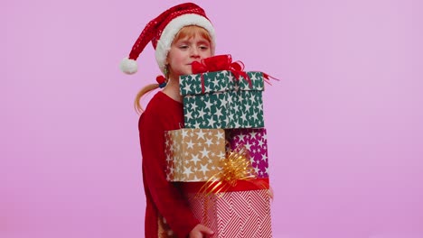 girl in christmas sweater santa hat smiling holding many gift boxes new year presents shopping