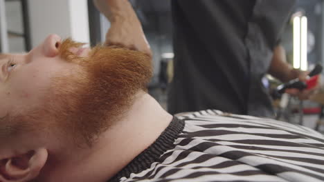 Barber-Dusting-Hair-from-Neck-of-Client-after-Beard-Trim