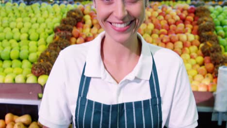 Female-staff-holding-fresh-green-apples-in-wicker-basket