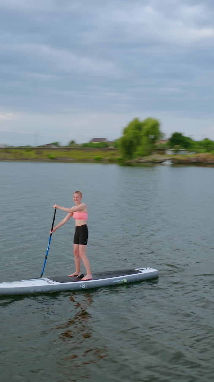 People Floating Standup Paddle Board. People standing on sup board and swims surfing on the river