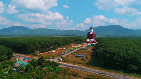 huge buddha massive buddha statue asia countryside orbit drone