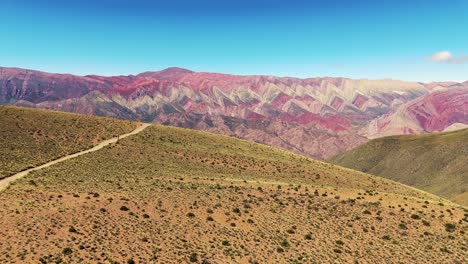 aerial dolly shot over tourists looking at the vibrant hillside of el hornocal