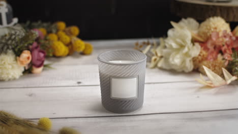 Moving-up-on-a-packshot-of-a-candle-with-a-white-lable-to-track-and-add-your-information-or-logo