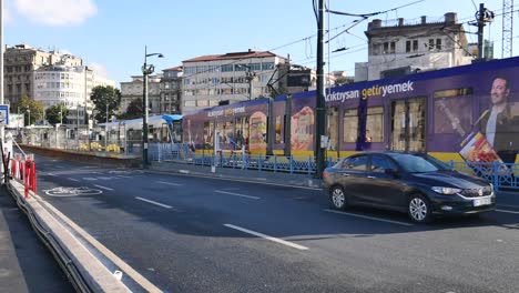 a tram travels down a city street.