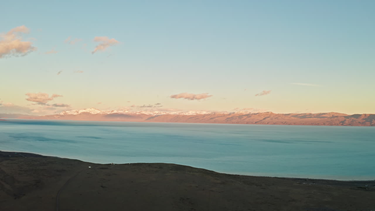 Beautiful Sunset over the Andes Mountains in Patagonia, Argentina.
Aerial Drone View of Electric Blue Lake and Dreamy Colorful sky as the Sun Sets