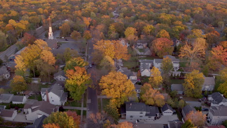 aerial push down pretty street in kirkwood, missouri in the fall at golden hour