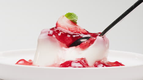 spoonful of strawberry panna cotta dessert