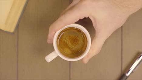 hand holding a cup of espresso