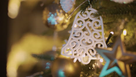 close up view of a christmas tree with christmas decorations hanging