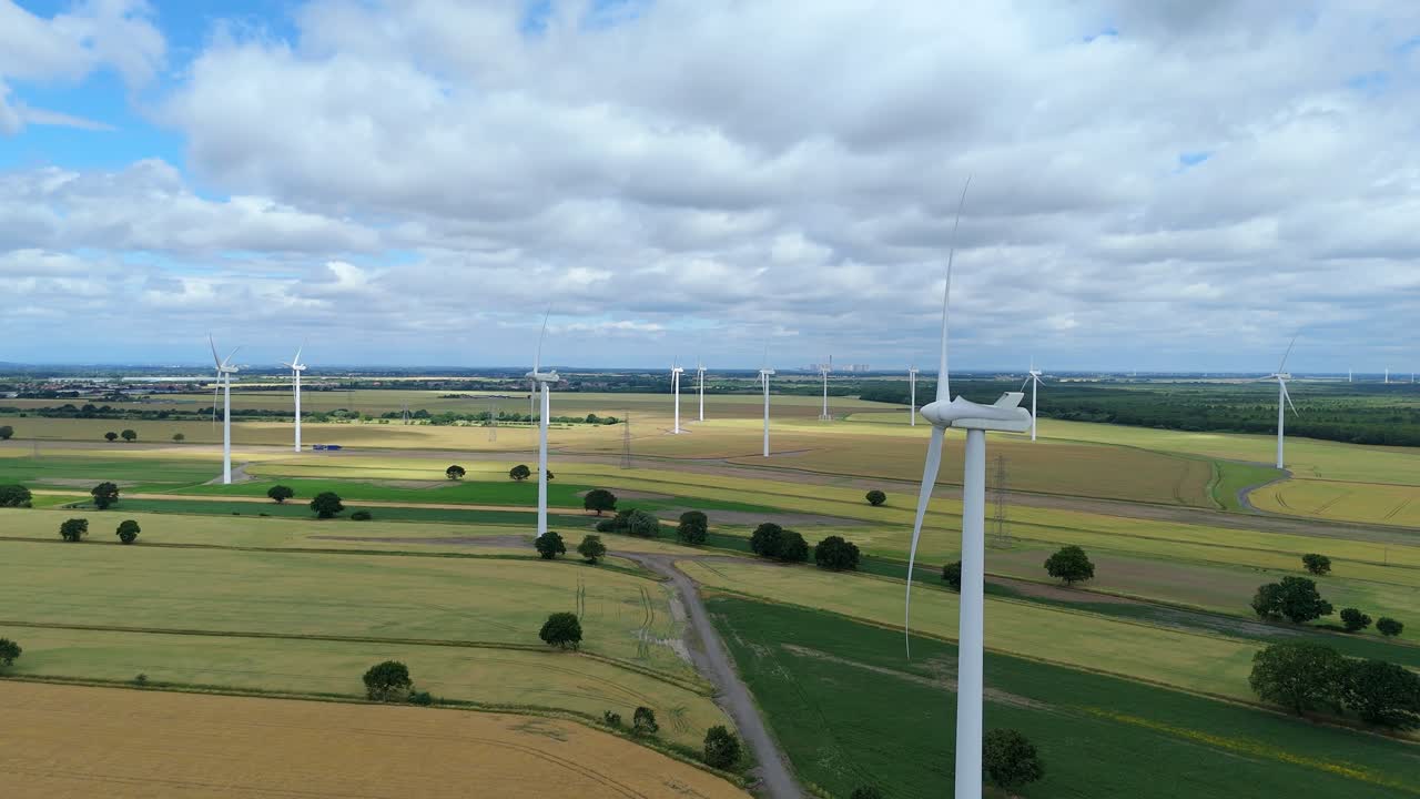 Aerial cinematic shot of wind turbine generating clean energy UK