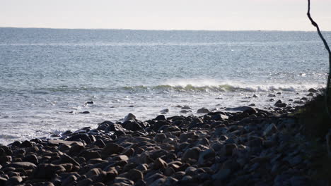 ocean waves crashing on rocky beach shoreline, 4k slow motion