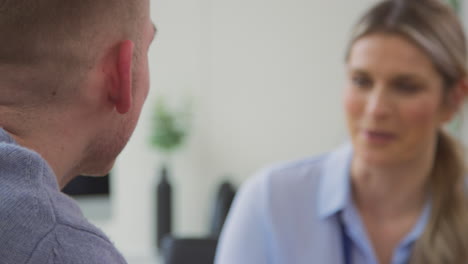 Close-Up-Of-Doctor-Talking-To-Crying-Male-Patient-Suffering-With-Mental-Health-Problems