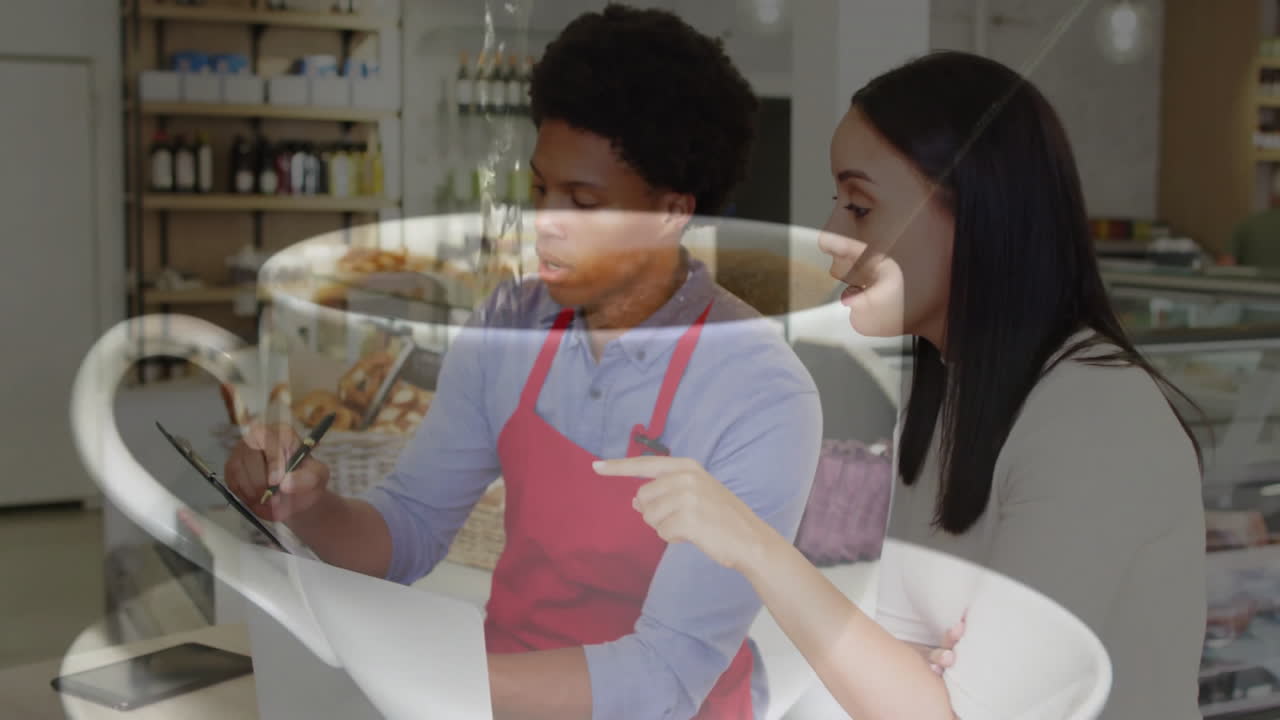 Barista writing clipboard at cafe counter, customer leaning with animated coffee cup icon overlay