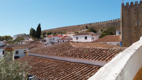 portugal, óbidos, amazing view of the medieval city wall over the charming houses and rooftops