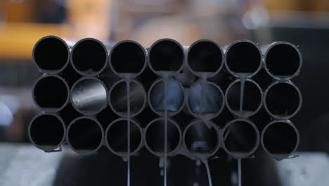 abstract background of steel pipes stacked on a pallet. pipe cutting technology