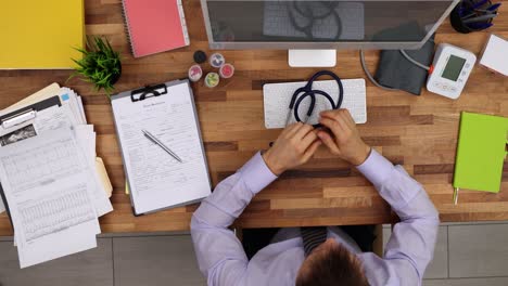 Overhead View of a Doctor's Desk with Stethoscope and Medical Records