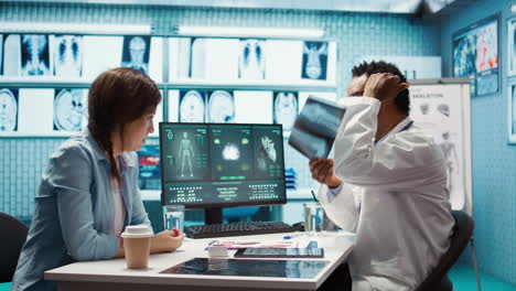 african american physician presenting the x ray diagnostics results to a patient