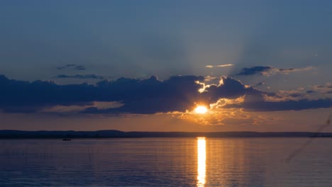 sunset over the lake with a fishing boat