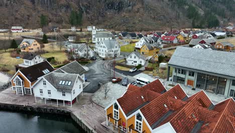 white tourist bus arriving mo modalen, aerial moving backwards revealing town center and seafront