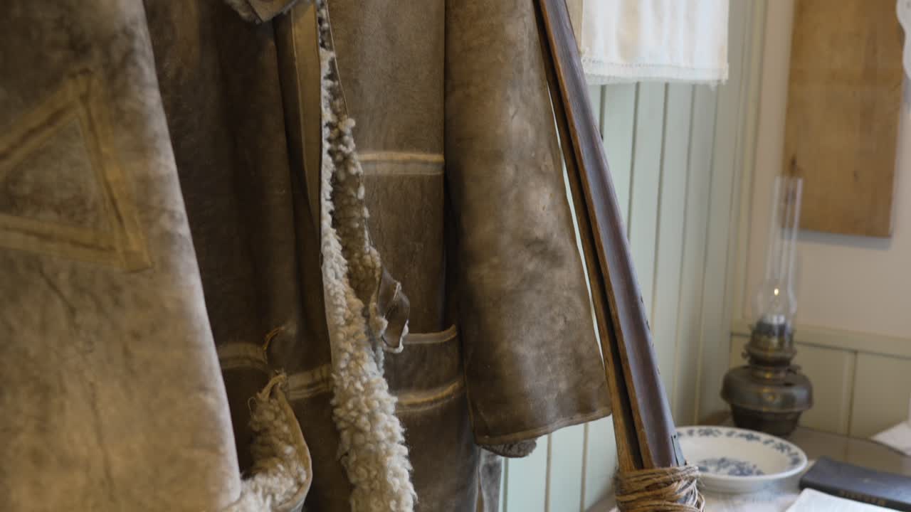 Shearling coat, embroidered towel, and vintage kitchenware in a cozy Flåm Museum interior—capturing Norway’s rural lifestyle and traditional home aesthetics