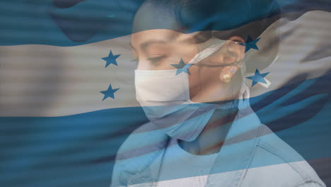 animation of flag of honduras waving over woman wearing face mask during covid 19 pandemic