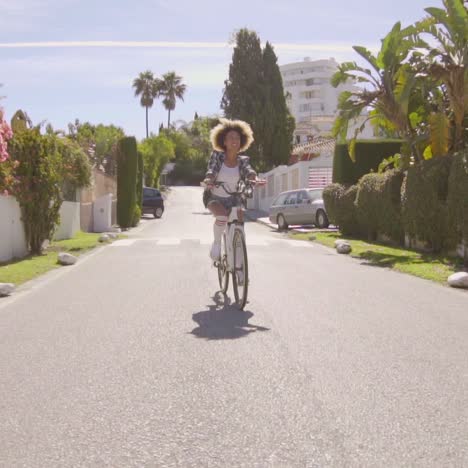 Young-Woman-Riding-The-Bicycle-On-The-Road