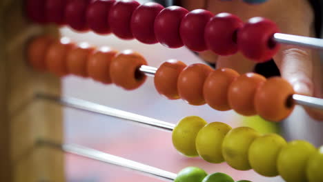 young boy counting with a colourful abacus in slow motion