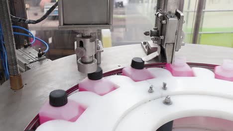 bottle capping machine on an automatic industrial line, liquid packaging system
