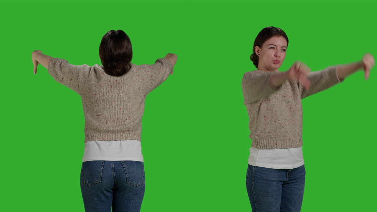 Woman giving thumbs down on green screen