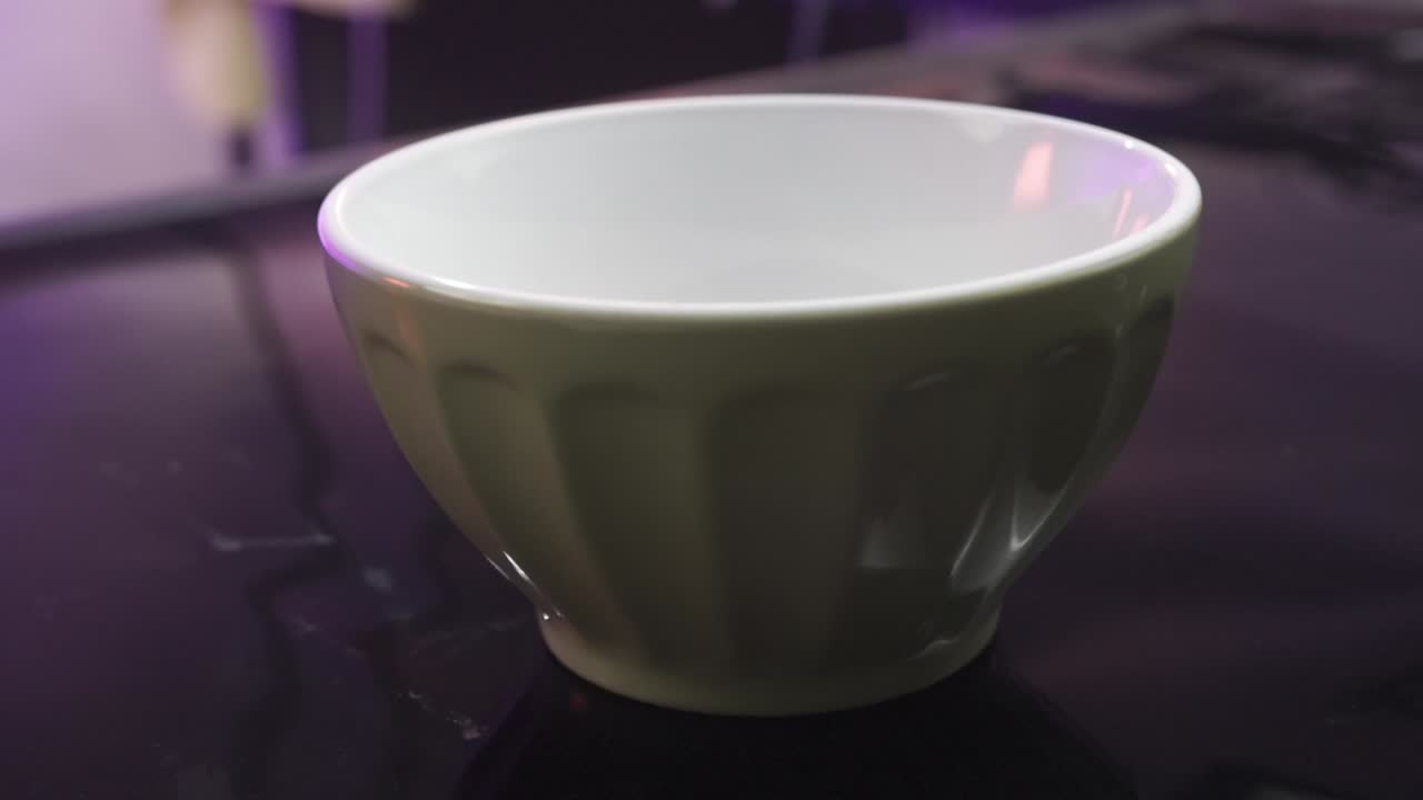 Close up shot of walnut being poured into a bowl, interior