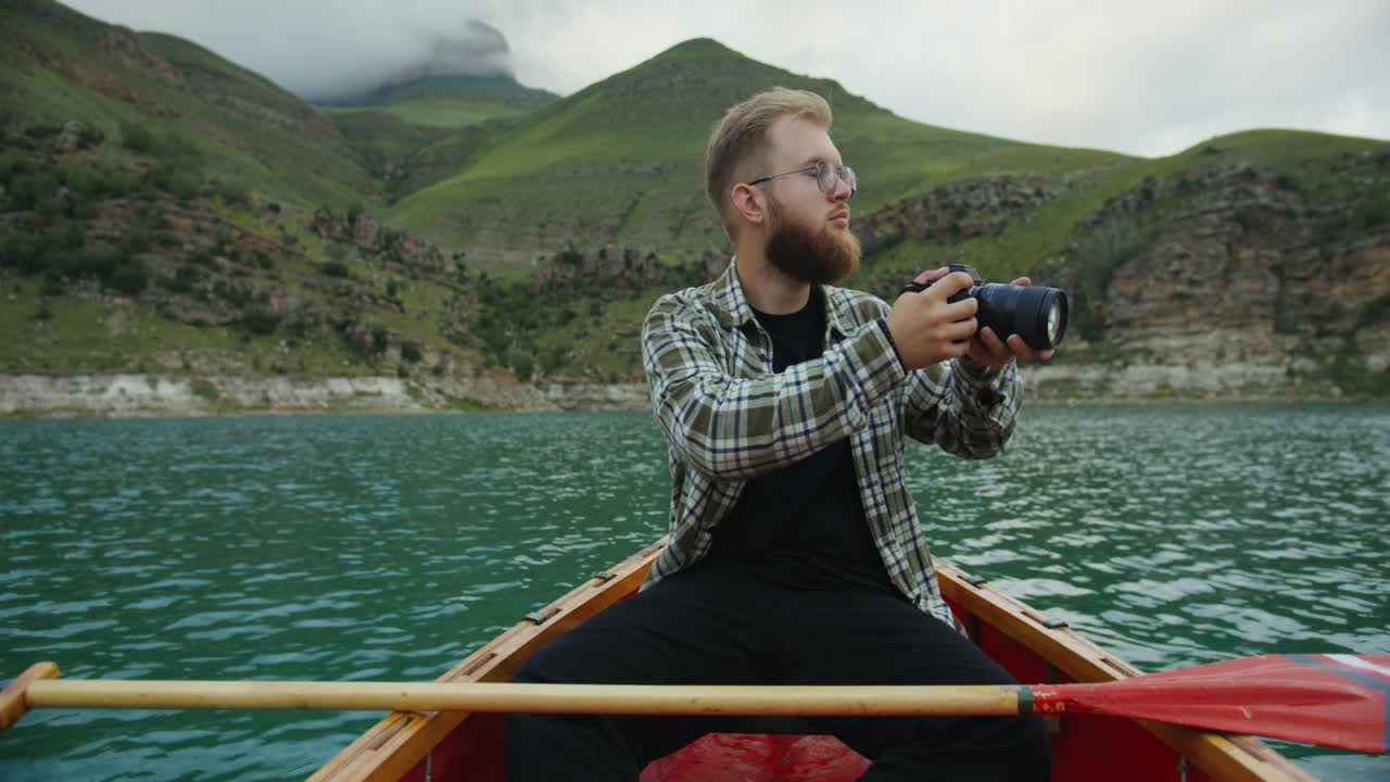 fotógrafo tomando fotos desde una canoa en un lago