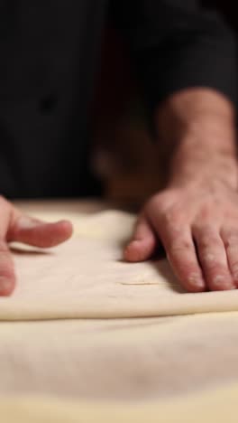 chef rolling out pizza dough