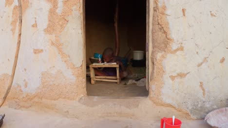 niño negro africano niño estudiando solo preparando la tarea para la escuela en una casa rural remota en el pueblo de áfrica