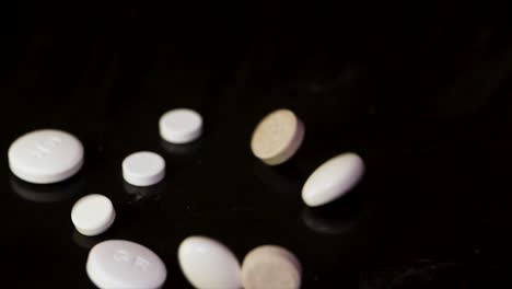 scattered pills on dark surface