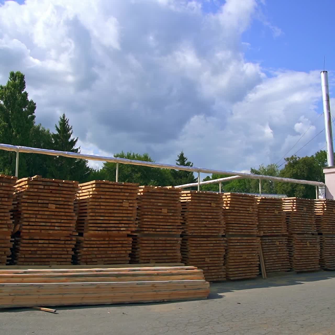 Wooden plank piled outside at the modern plant. Piles of wood for door manufacturing