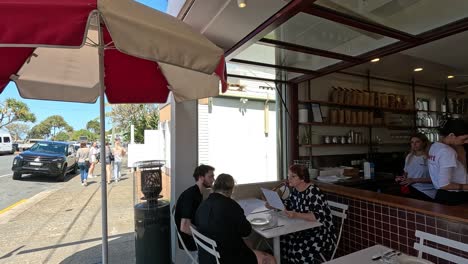 people enjoying a meal at a beachside restaurant